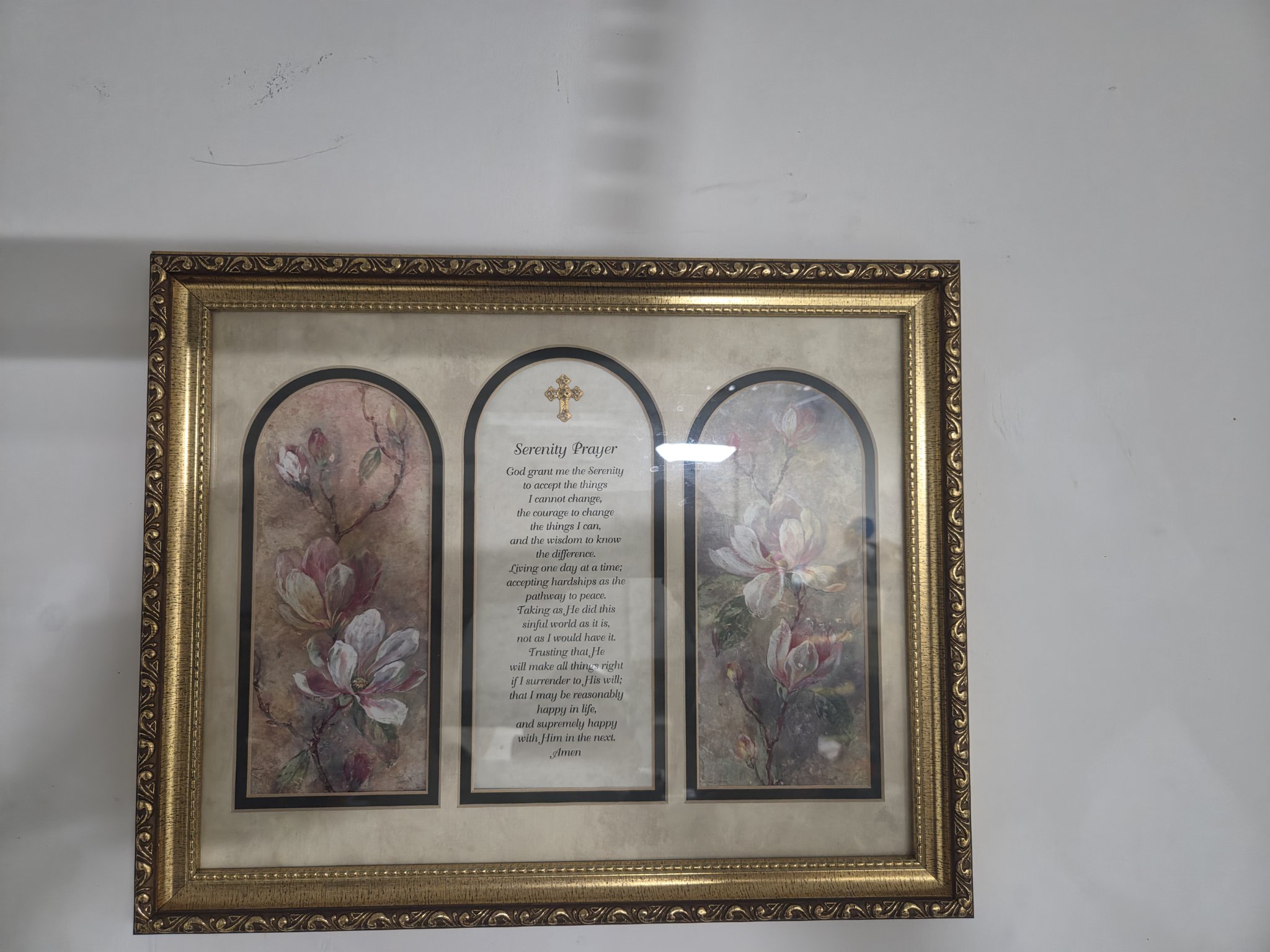Before — the photograph as it came off the phone: flat room light, and the room&rsquo;s glare standing on the glass over the right-hand panel